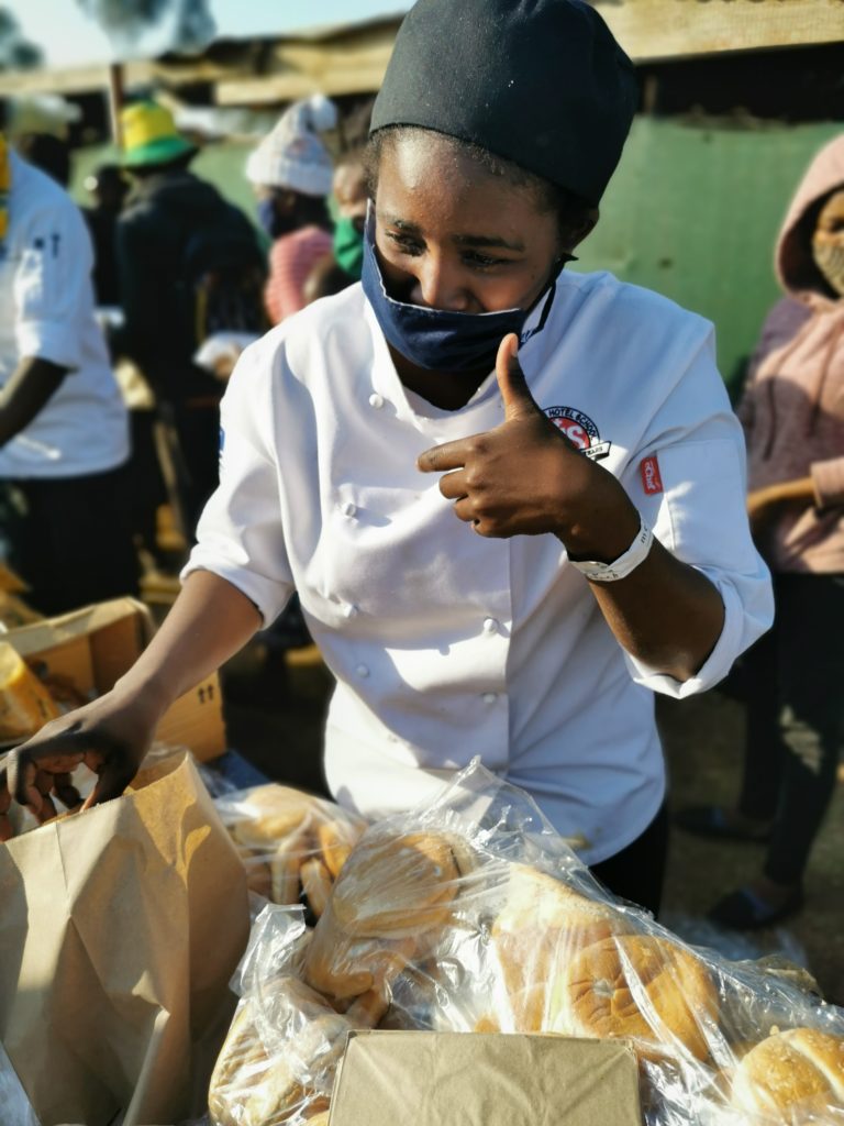 Chef serving bread on Mandela Day in Jackson Park