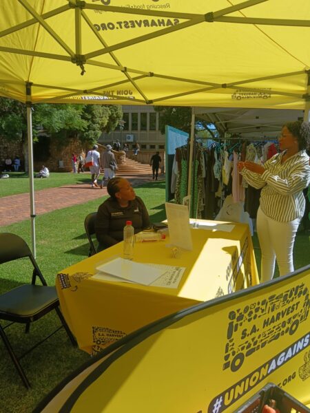 A Wits student speaks with an SA Harvest team member about volunteering and food rescue logistics.